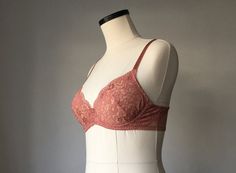 a white mannequin with a pink bra on it