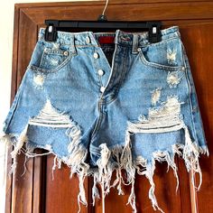 High Waisted, Distressed Jean Shorts Never Worn, Size S High Waist Ripped Blue Bottoms, Blue Ripped High Waist Shorts, Ripped Blue Short Bottoms, Blue Ripped Short Bottoms, Ripped High Waist Beach Bottoms, Distressed High-waisted Shorts For Beach, Ripped Blue Shorts, Ripped High-waist Beach Bottoms, Distressed Blue Short Length Bottoms