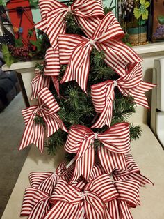 a christmas tree with red and white bows