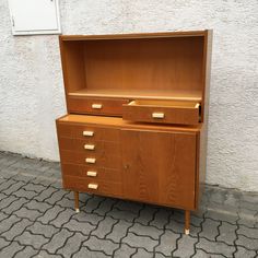 a wooden dresser with two drawers on it