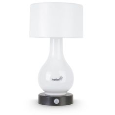 a white table lamp with a black base