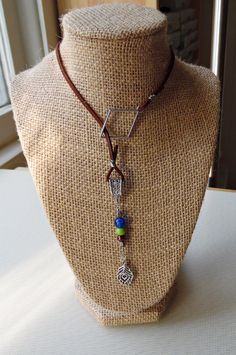 This brown faux suede lariat can be draped for a lower-sitting necklace--or double-wrapped for a shorter, choker-like look. Ornamented with a hand-beaded dangle made with Czech glass beads, as well as a silvertone peacock charm, this unique Peacock Feather Lariat completes any boho, southwest or casual look with simplicity and flair. Wire-wrapped by hand! You may also like our Peacock Beaded Necklace: https://www.etsy.com/listing/725488341/peacock-beaded-necklace-with-charm-and And our Peacock Feather Bracelet: https://www.etsy.com/listing/730270333/peacock-feather-bracelet-with-brown Peacock Feather Bracelet, Feather Bracelet, Tarot Bags, Peacock Feather, Vintage Button, Lariat Necklace, Look Plus, Casual Look, Czech Glass Beads