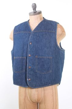 "vintage 1970s dark denim Carhartt vest. Extra warm cream sherpa fleece lining. 2 flat front pockets & Carhartt logo snaps. Looks great over cowboy shirts, or other work wear. Size XL. 44\" chest, 24\" Long Very good condition has some white spots but hard to see." Cotton Medium Wash Vest Outerwear, Vintage Cotton Vest For Outdoor, Vintage Cotton Vest With Button Closure, Vintage Cotton Vest Outerwear, Medium Wash Cotton Vest With Pockets, Dark Wash Cotton Vest With Pockets, Vintage Cotton Denim Vest With Pockets, Vintage Denim Blue Cotton Vest, Vintage Denim Blue Vest With Pockets