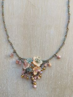 Vintage Colleen Toland Peach Apricot and Moss Green Petite Floral Necklace.  This lovely necklace is made by hand-painting resin flowers and beading them in an arrangement with tiny glass seed beads. The necklace itself is made with wired seed beads that are linked together. The finishing touch includes rare vintage glass beads in a pink barrel shape. It features a lobster claw closure and a 4-inch extender, allowing the length to be adjusted . The works shown are the last pieces from Colleen's Painting Resin, Romantic Jewelry, Romantic Jewellery, Jewellery Handmade, Floral Necklace, Resin Flowers, Green Flower, Lovely Necklace, Floral Vintage