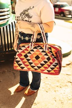 Our Orange Burst Aztec Duffel Bag makes traveling easy! This bag features a stunning bright colored Aztec pattern so you can take on vacation in style. Pack it full of your favorite Wild Junkie items and get ready for a weekend getaway! 19" x 9" x 11" Multicolor Satchel Bag For Vacation, Multicolor Weekender Bag With Adjustable Strap, Multicolor Satchel For Vacation, Summer Bags With Adjustable Strap For Weekend Trips, Summer Weekend Bags With Adjustable Strap, Summer Weekend Trip Bag With Adjustable Strap, Red Travel Bag With Adjustable Strap, Casual Red Bag With Luggage Sleeve, Adjustable Strap Tote For Weekend Trips