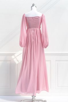 A fairytale-pink gown, the Persephone maxi dress in sparkling blush pink chiffon features a pleated bodice, long sleeves, smocked elastic back with zipper, a sweetheart neckline, and a full, sweeping skirt. Please Note- This item is final sale only. . Details: S: Bust 32"-36", Waist 26"-28", Length 58" M: Bust 34"-38", Waist 28"-30", Length 59" L: Bust 36"-40", Waist 30"-32", Length 60" Skirt Length Waist to Hem: 47" Center Back Zipper 100% Polyester Lined Dry Clean Only Imported Spring Prom Maxi Dress With Ruched Bodice, Pink Ruffled Chiffon Prom Dress, Feminine Ruched Floor-length Maxi Dress, Elegant Smocked Back Maxi Length Dress, Elegant Smocked Back Maxi Dress, Flowy Dress With Smocked Bodice And Sweetheart Neckline, Feminine Empire Waist Maxi Dress With Smocked Bodice, Feminine Floor-length Ruched Maxi Dress, Elegant Maxi Length Smocked Dress With Smocked Back