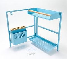 a blue shelf with two bins and a cutting board