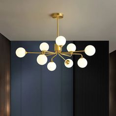 a chandelier hanging from the ceiling in a room with blue walls and wood paneling