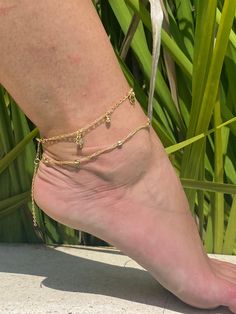 "18 Karat Gold Filled Anklet- Tarnish Resistant- Hypoallergenic Options Available Below Anklet lengths: 18 Karat Gold Filled Ball Chain Anklet length: 10\" 18 Karat Gold Filled Clover Chain Anklet length: 11.5\" Please message us if you would like to add extension chain or cut your chain to a custom size. If the item is cut it would be final sale. Material: 18 Karat Gold Filled. Gold-filled does not de-laminate or peel like Gold plated Jewelry nor does it tarnish as readily as silver. From time Adjustable Gold Ankle Wrap Anklet, Adjustable Chain Anklets For Festival, Gold Dangle Anklets With Adjustable Fit, Gold Adjustable Chain Anklet For Beach, Gold Adjustable Dangle Anklets, Dainty Adjustable Ankle Wrap Anklets, Gold Adjustable Ankle Wrap Anklet, Dainty Gold Anklets For Festivals, Gold Ankle Wrap Bracelets For Festivals