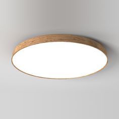 a circular wooden light fixture on a white wall