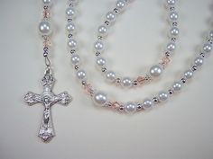 "Great Gift This Beautiful Rosary is handcrafted with 6mm  and 8mm White Czech Glass Pearl Beads.   Genuine Czech Glass Pearl Beads.  4mm Pale Pink Diamond Shaped Bicone Glass Beads.  The Rosary is 16 3/4\" from top of the Loop to bottom of Cross. ( Laid flat )  Leaf Sunburst Crucifix  This Beautifully made Rosary Crucifix features a Sunburst behind  Jesus and Detailed Images on all 4 Corners.  Made in Italy, 1 1/2\" long and silver oxidized. Madonna and Jesus Rosary Center Piece This center pie White Rosary, Blue Rosary, Catholic Necklace, Crucifix Necklace, The Rosary, Rosary Catholic, Beading Wire, Onyx Bead, Pink Diamond