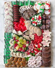 an assortment of christmas cookies and pastries on a board