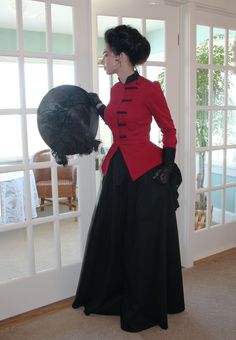 This fabulous Victorian power suit is a must have! The asymmetrical front closure on the twill jacket and braid detail are so very Victorian and period-correct. A small black high collar trimmed in gimp braid, matching black deep cuffs and long full pleated peplum - ample enough to accommodate a bustle - complete this romantic look. Faceted buttons adorn the cuffs and braid detail on the jacket front. The black twill 3-gore skirt features a comfortable elastic waist. Dry clean only. Priced separ Fitted Blazer With Stand Collar, Fitted Evening Outerwear With Button Cuffs, Fitted Evening Outerwear With Stand Collar, Fitted Blazer With Stand Collar And Covered Buttons, Fitted Outerwear With Stand Collar For Evening, Elegant Black Blazer For Costume, Fitted Blazer With Button Cuffs And Stand Collar, Black Blazer With Button Cuffs And Stand Collar, Victorian Suits