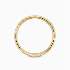 a yellow gold wedding ring on a white background