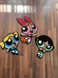 three rugs that look like cartoon characters are on the floor in front of a wooden floor