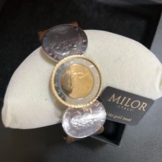 14k Gold Bezel Stainless Milor Italy Repvbblica Italiana L500l Coin Bracelet. Circa 1998 The L 500 Coin Was Minted From 1958 To 2001 Milor Italy Coin Cuff Bracelet Sterling Silver Bezel / Stainless Steel Hinge Condition Coins Are Real Italy Obsolete Coins The Bezel Of Top Coin Is 14kt With Stainless Steel Hinge Signed On Back. Luxury Nickel-free Jewelry For Anniversary, Luxury Nickel-free Jewelry For Formal Occasions, Luxury Hammered Bracelets Gift, Elegant Coin Shaped Metal Jewelry, Luxury Hammered Bracelets As Gift, Luxury Hammered Bracelets For Gift, Luxury Hammered Jewelry For Formal Occasions, Elegant Adjustable Coin-shaped Jewelry, Elegant Hammered Coin Jewelry