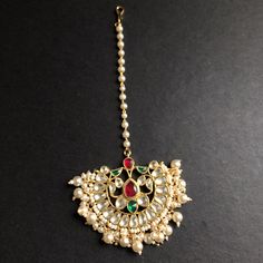 Russhi Chandbali Style Kundan Mang Tika with Pearls Features: Mang Tika: Approx. 5 Inches Hook feature to tie the mang tika to hair Made in Brass with golden finish and high quality Kundan stones Lightweight Jewelry Suitable for any occasion and traditional or Modern attire Ready to ship and available for local pickup from 23059. Please message us for more details Free shipping on orders above $75 within USA. Mang Tika, Light Weight Jewelry, Colored Diamonds, New Product, Diamond Necklace, Wedding Day, Pendant Necklace, Brass, Stone