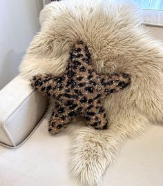 a star shaped pillow sitting on top of a white couch