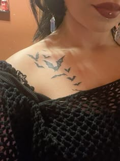 a woman with a bat tattoo on her chest