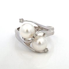 White Pearls and Diamond Vintage 14k White Gold Bypass Ring ~  Vintage Estate ~ Size 8.5 -  ET2175 A unique take on a white pearl and diamond bypass ring!  This ring gives the impression of swirling movement and looks absolutely stunning on. Ring Size: 8.5: can be resized Metal Content: 14k White Gold Gemstones:  2 White Cultured Pearls Size in mm: 8 Diamonds: 4 Natural/Genuine Round Brilliant Cut Carat: .08 ctw Clarity: SI1-SI2 Color: G/H Weight: 6.42 Grams Stamps: 14k 585 Cardow Condition: Very Good Estate- Small divots noted to pearl nacre Each piece is thoroughly examined and refinished as needed by our professional jewelers, tested to guarantee metal content,  graded by our in-house GIA (Gemological Institute of America) Graduate Gemologist, and inspected for quality before being care Classic White Bypass Ring For Formal Occasions, Luxury White Gold Bypass Ring For Anniversary, White Pearl Ring With Polished Finish For Anniversary, Diamond White Bypass Ring For Formal Occasions, Formal Diamond White Bypass Ring In Fine Jewelry Style, Fine Jewelry White Pearl Ring Stamped 14k, White Pearl Ring Stamped 14k, Formal White Bypass Ring With Diamond Accents, White Open Ring With Tension Setting