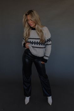 DETAILS: Our Maeva Cable Knit Sweater is a stand out piece for your wardrobe! This sweater has a twisted detail throughout the sweater that adds a unique and eye-catching element to its design. The neckline is a high scoop and there is a thick black trim on the neckline, cuffs, and hemline. The sweater has small cable knit and very soft to touch material. It has stretch and runs true to size. Pair this sweater with leggings or jeans and your favorite boots for a cute outfit!! CONTENT & CARE: 47% Polyester. 35% Acrylic. 15% Nylon. 3% Spandex. SIZE & FIT: Model is 5'6" The model is wearing a size small. Fits true to size The Fabric has stretch Chic Stretch Chunky Knit Sweater, Trendy Cropped Sweater For Fall Night Out, Trendy Cropped Sweater For Night Out In Fall, Chic Cropped Crew Neck Sweater For Winter, Trendy Cropped Sweater For Winter Nights, Chic Crew Neck Cropped Sweater, Trendy Cropped Sweater For Night Out In Winter, Chic Fall Sweater For Night Out, Knit Top For Night Out In Fall