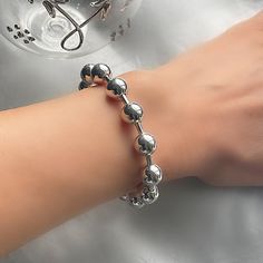 This beautiful sterling silver ball bracelet features highly polished beaded links. The bracelet is available in  19.05 cm (7.5'') or 20 cm (8'') and features highly polished beaded links and 10 mm balls intersecting.  Stylish and sophisticated this is the perfect piece of jewellery to go with any outfit. Elegant Sterling Silver Ball Chain Bracelets, Elegant Sterling Silver Ball Chain Bracelet, Modern Silver Bracelet With Round Beads, Modern Silver Bracelets With Round Beads, Elegant Silver Bracelet With Ball Chain, Silver Beaded Ball Chain Bracelet, Modern Silver Jewelry With 8mm Beads, Silver Beaded Bracelets With Ball Chain, Ball Bracelet