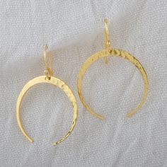 Handmade Crescent Moon Earring, Brass Hammered Dangle Earrings, Moon Charm Earring, Gold Plated Fashion Jewelry, Hook Earrings For Women These stunning brass dangle earrings are handmade with skillful craftsmanship and feature a hammered design that exudes a unique charm, catching the eye. Made from high-quality brass and adorned with a luxurious gold-plated finish, these statement earrings are a testament to both craftsmanship and style. The elegant dangle and drop ear wire design makes them a Gold Crescent Hammered Earrings, Gold Hammered Crescent Earrings, Elegant Brass Earrings With Moon Charm, Elegant Hammered Crescent Earrings, Elegant Nickel-free Half Moon Earrings, Elegant Adjustable Moon Shaped Earrings, Elegant Half Moon Nickel Free Earrings, Elegant Half Moon Nickel-free Earrings, Metal Crescent Earrings With Ear Wire