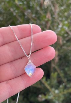 This unique healing crystal necklace is perfect for helping with anxiety and stress relief. Moonstone is a unique gemstone for calming and grounding. It's perfect for meditation and getting back to your own wisdom. Our exclusive, Rainbow Moonstone gemstone necklace is a perfect addition to any wardrobe. The gemstone pendant is a unique, leaf style shape with iridescent colors. The crystal gemstone is wire wrapped by hand and is carried by a genuine .925 sterling silver box style chain.  A spring ring clasp secures the chain.  All together creating a perfect piece for you or that special someone.  About the Gemstone:  ✨Moonstone is a very beautiful gemstone created by nature. Here at Rachel Dunn Jewelry we use only high quality Moonstones in our pieces.  ✨Moonstone is believed by ancient cu Moonstone Pendant Necklace, Meditation Jewelry, Personalized Pendant, Moonstone Necklace, Silver Box, Unique Handmade Jewelry, Moonstone Pendant, Unique Gemstones, Gorgeous Necklaces