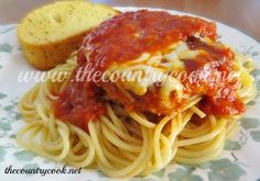 spaghetti with meat sauce and bread on a plate