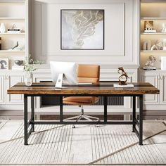 a desk with a laptop on top of it in front of some bookshelves