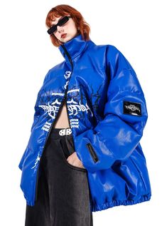 Oversized puffer jacket in a vibrant electric blue color. Features a striking black graphic across the chest depicting skeletal wings or a ribcage design, reminiscent of gothic or metal aesthetics. High collar for added warmth and style. Full-length front zipper closure in contrasting black. Model info Height: 176cm Weight: 46kg Wearing size: M Urban Puffer Jacket For Spring Streetwear, Urban Outerwear With Graphic Print For Halloween, Urban Halloween Outerwear With Graphic Print, Blue Graphic Print Outerwear For Streetwear, Halloween Graphic Print Outerwear For Streetwear, Halloween Graphic Print Streetwear Outerwear, Trendy Blue Outerwear With Graphic Print, Oversized Alternative Outerwear For Streetwear, Edgy Blue Outerwear For Fall