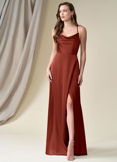 a woman in a long maroon dress with one leg slited up and the other side split