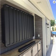 the outside of a house with an oven on it's back porch and pool in the background