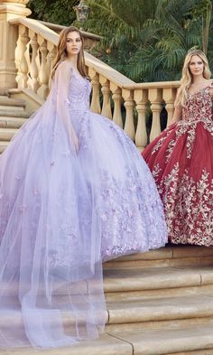 two women in gowns standing on stairs