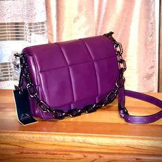 Brand New, With Tags. A Beautiful Shoulder Bag In The Vivid Purple Color Of Eggplant. Made Of Buttery Soft Vegan Leather, With A Bottega Like Seam Pattern And Air Pumped Flap. With A Long Detachable And Adjustable Shoulder Strap And Gun Metal Colored Hardware And Chain Handle That Also Can Be Detached Or Hidden Inside The Purse. One Zippered Compartment With A Small Zippered Inner Pocket. Good Size (10.5 X 7.5 X 4”); Big Enough To Contain All Your Daily Essentials. Made In Italy. Very Pretty! Purple Shoulder Bag With Removable Pouch For Office, Purple Office Shoulder Bag With Removable Pouch, Purple Rectangular Bags With Chain Strap, Purple Office Crossbody Shoulder Bag, Purple Crossbody Bag With Chain Strap, Purple Everyday Bag With Chain Strap, Everyday Purple Shoulder Bag With Chain Strap, Purple Shoulder Bag With Chain Strap For Everyday, Purple Leather Shoulder Bag With Chain Strap