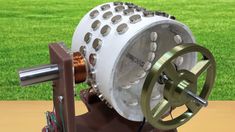 a machine that is sitting on top of a wooden table with grass in the background