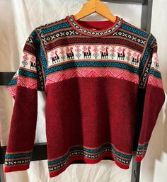 "Hand-knit Traditional Ecuadorian Print deep red sweater with vibrant blue and striking black and white geometric and alpaca intarsia pattern! Super super soft. I want to live in this fabric all of winter. Oh my god. What a perfect blend. Measurements: Shoulder to Shoulder: 15\" Chest: 33\" Waist: 32\" Length: 21\" Sleeve Length: 18.5\": this piece is for those that are short Bottom Hem: 33\"" Fall Knit Patterns With Crew Neck, Red Jacquard Knit Sweater For Winter, Red Nordic Knitted Sweater, Red Nordic Style Knitted Sweater, Red Fair Isle Sweater For Winter, Casual Fair Isle Long Sleeve Pattern, Nordic Multicolor Sweater For Fall, Alpaca Crew Neck Sweater, Multicolor Nordic Sweater For Fall