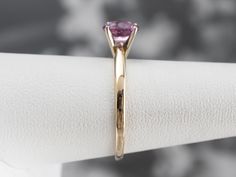 The focal point of this ring is absolutely the bright, rich, glowing pink sapphire set at the center! The simple engagement mounting, with balanced shoulders and high mounted prongs, is the perfect frame for this sweet stone and will sit nicely next to a variety of wedding band styles. Metal: 14K Yellow and White Gold Gem: Pink Sapphire 1.00 Carat Gem Measurements: 5 x 6.5 mm, Oval Ring Size: 7 Marks: "14K" Stamped on the inside band Pink Sapphire Ring In Yellow Gold With Round Cut, Yellow Gold Pink Sapphire Ring With Round Cut, Pink Gold Sapphire Ring With Prong Setting, Pink Sapphire Ring With Round Cut Center Stone, Pink Sapphire Ring With Center Stone, Classic Pink Solitaire Wedding Ring, Pink Amethyst Ring With Brilliant Cut, Pink Brilliant Cut Round Amethyst Ring, Pink Brilliant Cut Amethyst Ring