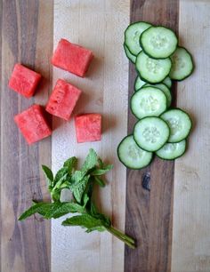 cucumber, watermelon and mint cut up on a wooden cutting board