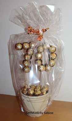 a bag filled with chocolates sitting on top of a wooden table next to a wall