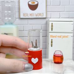 a person is holding a small device with liquid in it and another item next to it