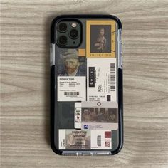 an iphone case with some tickets on the front and back cover, sitting on a wooden surface