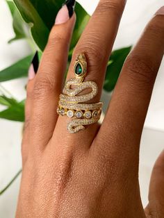 This gorgeous ring is 18kt gold plated and adjustable. Adjustable Open Snake Ring For Promise, Adjustable Gold Emerald Ring For Anniversary, Gold Plated Crystal Ring With Vs Clarity, Gold-plated Crystal Ring With Vs Clarity, Elegant Adjustable Gold Emerald Ring, Adjustable Gold Gemstone Rings, Adjustable Gold Emerald Ring As Gift, Adjustable Gold Emerald Ring Gift, Adjustable Yellow Gold Emerald Ring Gift