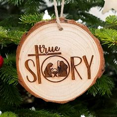 a christmas ornament with the words true story on it hanging from a tree