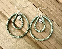 These double teardrop beaded hoop earrings are so pretty!  They are nearly 2 inches long and 1 1/2 inches wide.  The turquoise colored seed bead teardrop hoops have a small heart dangling in the middle.  I have a vast collection of seed beads.  Please message me if you would like a different color.  I probably have it, and will make a custom order for you.  We also have these hoops in different colors in the shop.  ~I use high quality hypoallergenic materials along with many different colors and Handmade Turquoise Hoop Earrings, Western Diy, Seed Bead Hoop Earrings, Earrings Handmade Beaded, Wood Hoop Earrings, Bead Hoop Earrings, Wire Wrap Jewelry Designs, Boho Hoop Earrings, Handmade Hoop Earrings