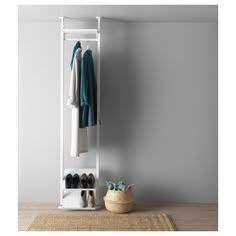 a white coat rack sitting on top of a wooden floor next to a basket filled with shoes