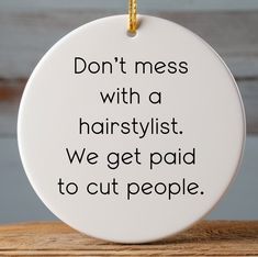 a ceramic ornament that says don't mess with a hairstylist we get paid to cut people