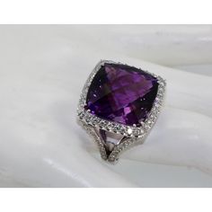 This is part of Chairish’s Fine Jewelry assortment.  This huge Amethyst ring is 25 carats of a mixed cut Amethyst.  This ring has a Diamond border and also Diamonds down the shank.  Just arrived from Italy and is an amazing piece.  This Amethyst is a cushion cut and the Diamonds total 1.50 carats for a total of 26.50 carats of gemstones.   This ring weighs in at 19 grams and is a US size 7.50 which can be re-sized up or down.  The color of this Amethyst is a deep Amethyst purple and matches the Amethyst earrings listed.  Amethyst is the birthstone of January babies but I love Amethyst it is a deep purple and glows especially at this size, 25 carats with a Diamond border of 1.50 carats.  Do not wait. Luxury Amethyst Ring With Diamond Accents For Anniversary, Purple Brilliant Cut Diamond Ring For Formal Occasions, Purple Cushion Cut Brilliant Ring, Formal Amethyst Diamond Ring With Diamond Cut, Formal Amethyst Diamond Cut Ring, Purple Brilliant Cushion Cut Rings, Formal Diamond Cut Amethyst Ring With Diamonds, Formal Purple Diamond Ring With Brilliant Cut, Luxury Amethyst Cushion Cut Ring For Formal Occasions