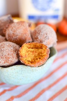 powdered sugar covered doughnuts in a bowl on a table