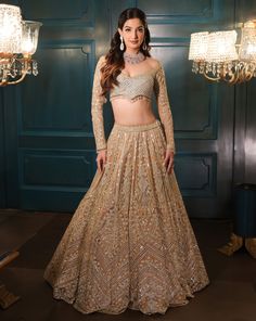 This lehenga set is hand embroidered in floral and geometric motis with a mix of light gold and sequin embroidered. Paired with a full sleeves embroidered wide-neck blouse and match dupatta.DELIVERY TIMEPlease allow 8-12 weeks for your outfit to arrive.FABRIC DETAILSNetProfessional cleaning only. Festive Saree With Intricate Embroidery And Long Sleeves, Gold Anarkali Set With Intricate Embroidery And Long Sleeve, Long Sleeve Lehenga With Intricate Embroidery For Eid, Embroidered Long Sleeve Georgette Lehenga, Long Sleeve Sets With Intricate Embroidery For Reception, Long Sleeve Lehenga With Dabka Work For Eid, Long Sleeve Anarkali Blouse Piece With Mirror Work, Anarkali Blouse Piece With Mirror Work And Long Sleeves, Anarkali Sets With Long Sleeves For Reception